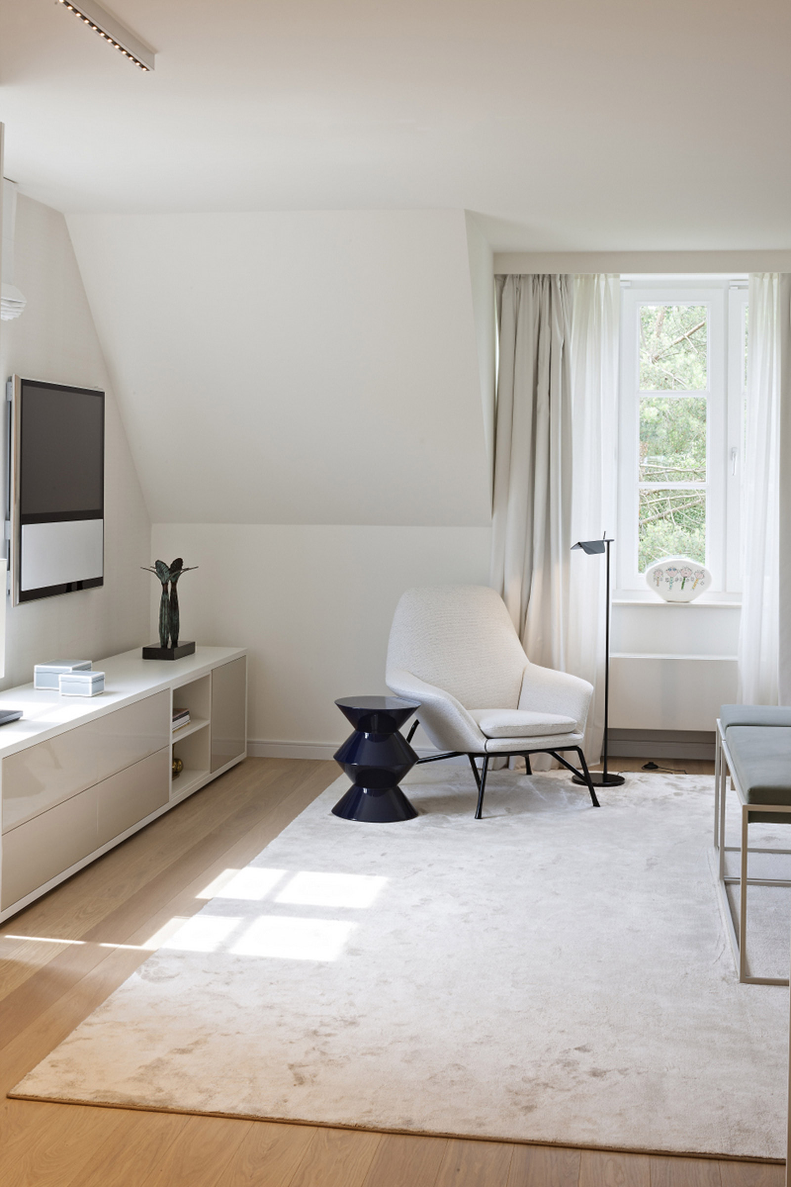 Minimalist style white room with armchair and simple furniture