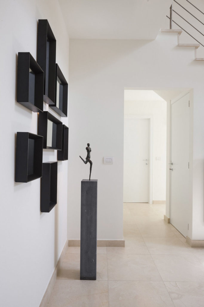 handicraft sculpture of a man in black tone in a hallway